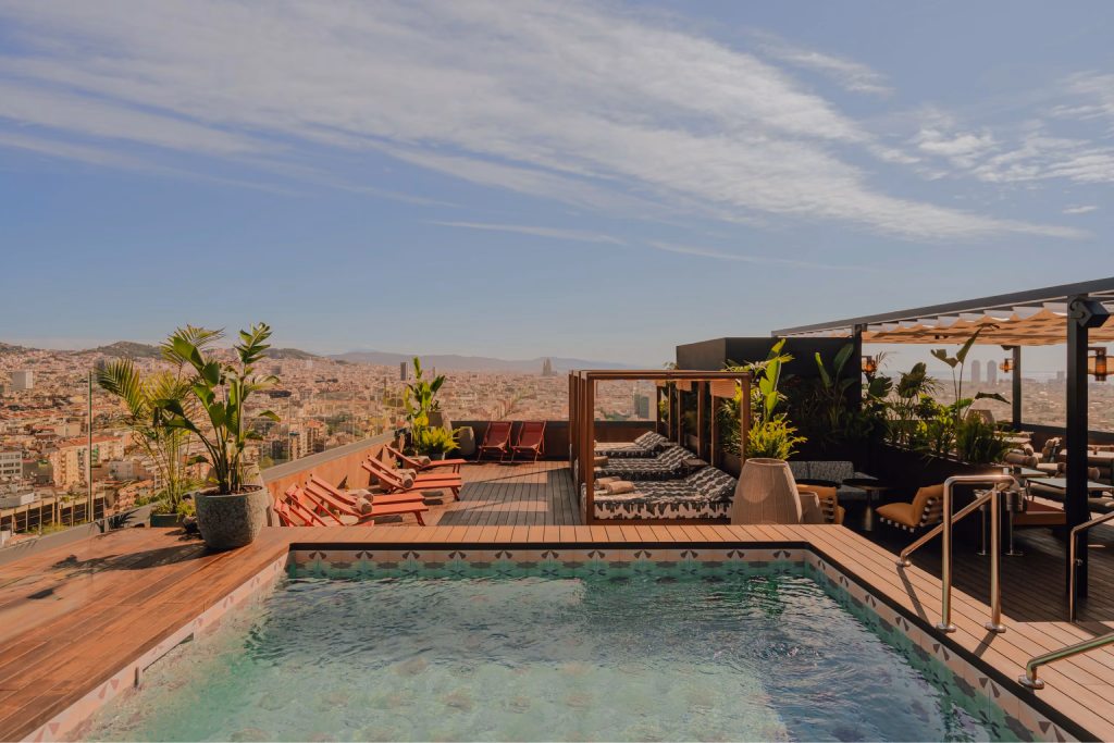 A rooftop hotel terrace overlooking a city